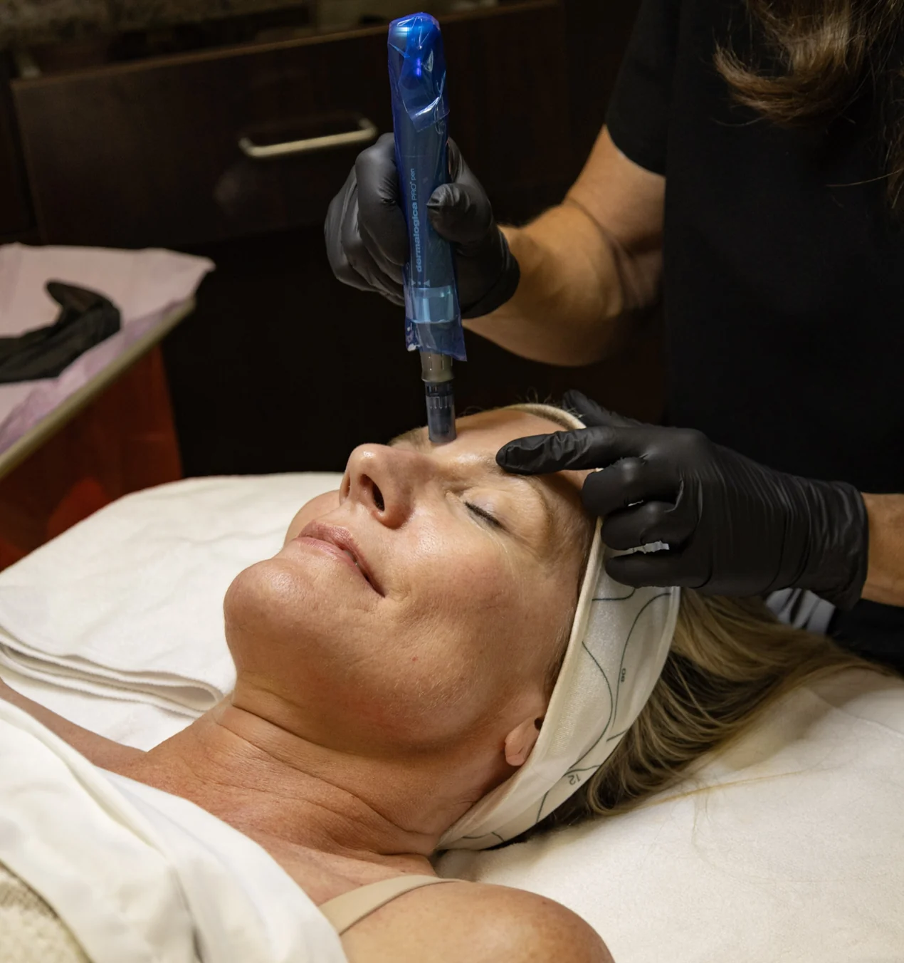 Rachel performing a microneedling treatment on a client's cheek